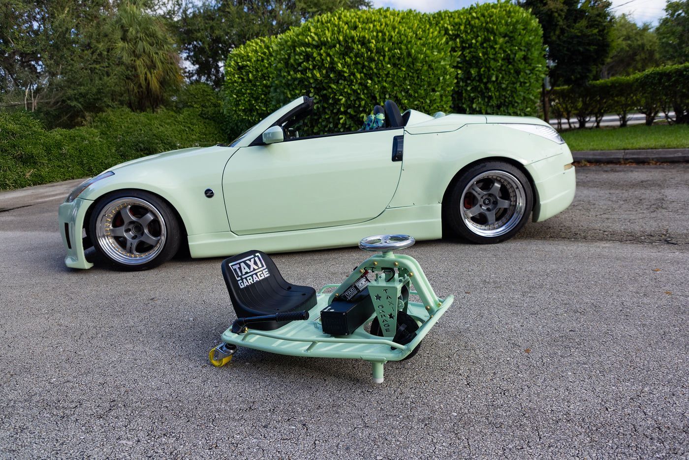 Drift cart next to a matching sports car