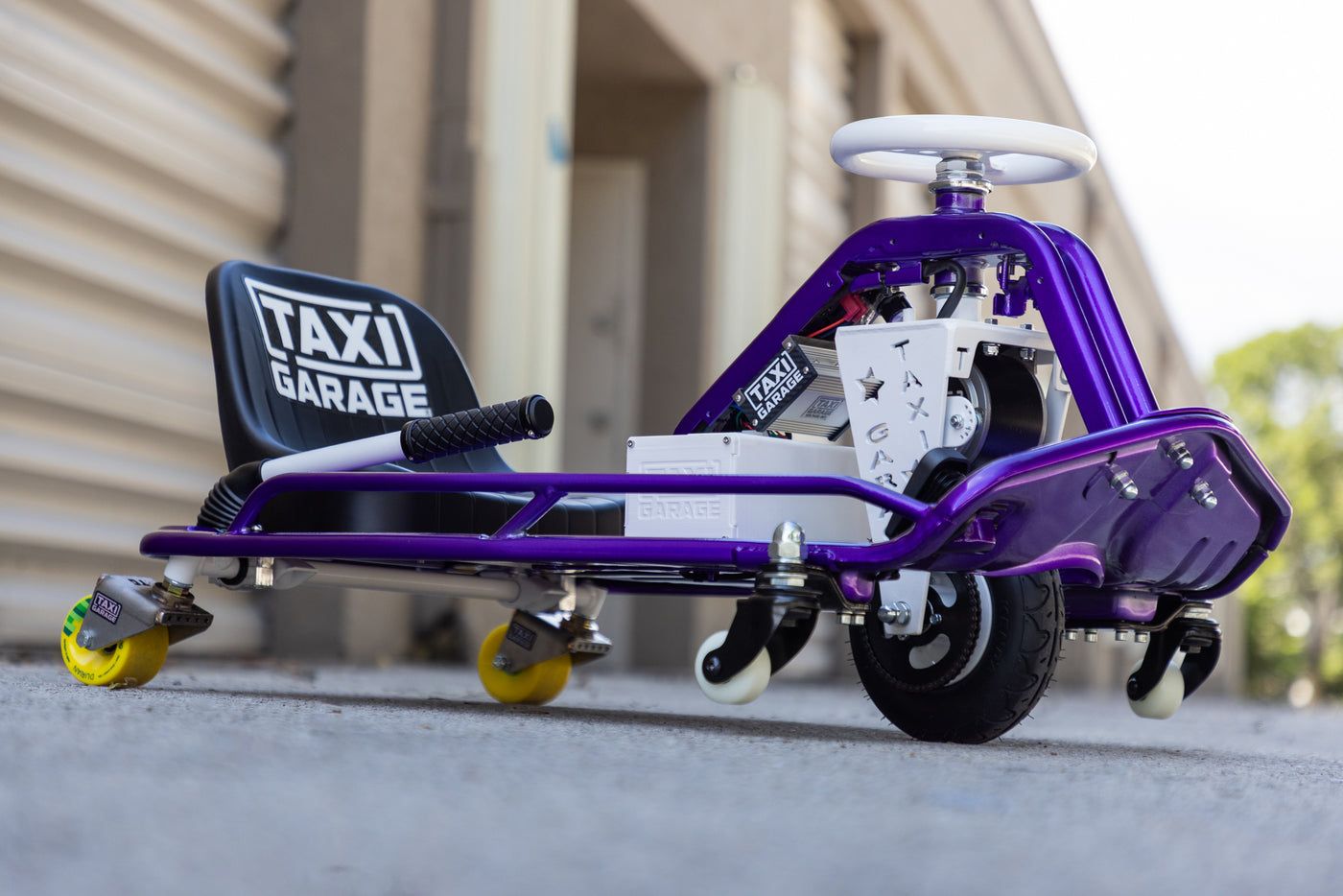 Purple and white drift cart with caster rear wheels